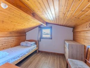 a room with two beds and a wooden ceiling at Maison 3 chambres avec jardin, proche plage et centre, Biscarrosse-Plage - FR-1-521-35 in Biscarrosse-Plage +2 photos