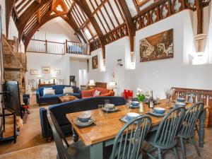 a living room with a wooden table and chairs at The Old School House 1-uk32061 in Burwarton