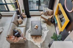 an overhead view of a living room with a table and chairs at The Pastel I Closest Available Airbnb To Stampede in Calgary