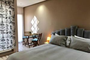 a bedroom with a bed and a table with chairs at Contemporary Top Floor Bourgogne - By AppartAli in Casablanca