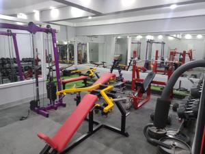 a gym with red and yellow tread machines at Al Hussam Hotel Apartments in Muscat +15 photos