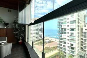 a building with a balcony with a view of the ocean at Marina Urban Sea View - By AppartAli in Casablanca