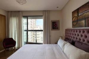 a bedroom with a large bed and a large window at Marina Urban Sea View - By AppartAli in Casablanca