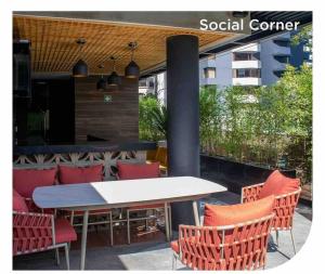 a table and chairs in front of a social center at Eon-ClarionSuites Apart-estudio zona 10 con AC in Guatemala