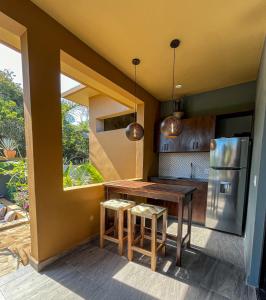 a kitchen with a wooden table and a refrigerator at Quinta Viajero in Zipolite