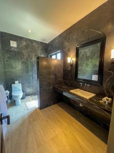 a bathroom with a sink and a toilet at Quinta Viajero in Zipolite +13 photos