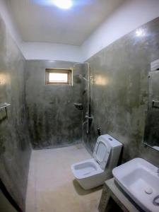 a bathroom with a toilet and a sink at Knuckles Range Bunglow in Kandy