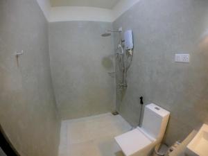 a bathroom with a shower and a toilet at Knuckles Range Bunglow in Kandy
