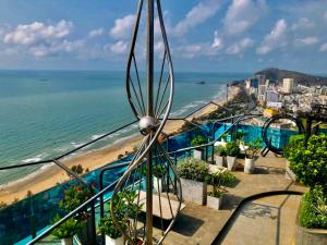a view of the beach from the balcony of a resort at Qvungtau-3BR Oasky- Seaview apartment Vung Tau in Vung Tau