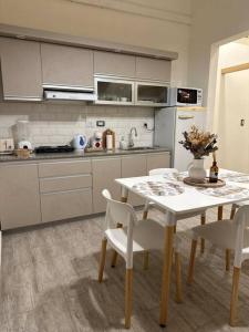 a kitchen with a white table and chairs and a white table and chairsktop at Martita House in Clorinda