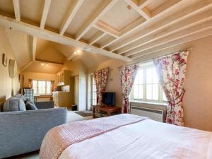 um quarto com uma cama e uma sala de estar em Oaklands Farm - Cottage 4 em Broughton