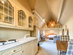 a kitchen with a sink and a bed in a room at Oaklands Farm - Cottage 4 in Broughton