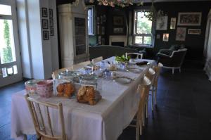 a long table with food in jars on it at Rose e Cioccolato B&B in Borgo Val di Taro