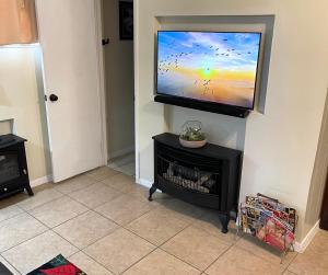 a flat screen tv hanging on a wall at 3Mins.Airport/Fort Bliss-Pet Friendly-Washer/Dryer in El Paso