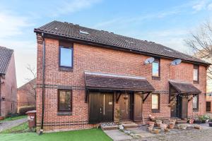 a brick house with a black roof at Sutton Apartment, Greater London in Sutton