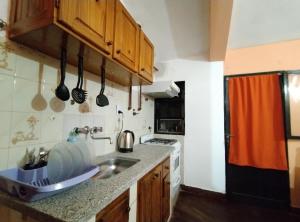 a kitchen with a sink and a counter top at Casa Suyay in Londres