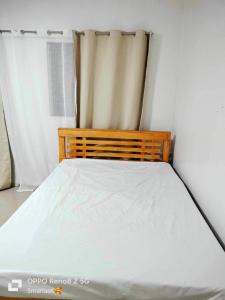 a bed in a room with a white bedsheet at 3K’s Transient house in Bagac in Bataan +8 photos