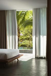 a bedroom with a bed and a large window at Long Set Resort in Koh Rong Island