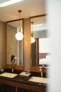a bathroom with two sinks and two mirrors at Long Set Resort in Koh Rong Island