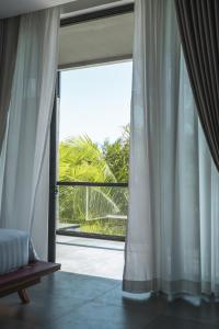 a bedroom with a large window with a view at Long Set Resort in Koh Rong Island