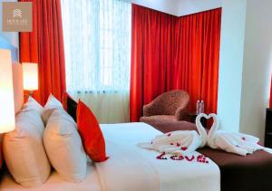 Postel nebo postele na pokoji v ubytování Hock Lee Hotel & Residences