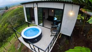 a large bath tub sitting on the deck of a house at Glamping Moterio in Santa Rosa de Cabal