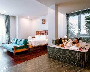 シェムリアップにあるTwo Seasons Siem Reap Hotelのベッドルーム1室(大型バスタブ、子犬付)