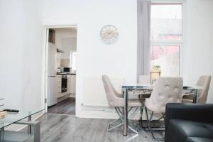 a living room with a dining room table and chairs at Elegant 4Bed House near the City Centre in Liverpool