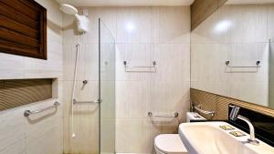 a bathroom with a shower and a toilet and a sink at Suítes Jardins de Flecheiras in Flecheiras