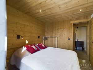 a bedroom with a white bed with red pillows at Appartement Montvalezan-La Rosière, 6 pièces, 6 personnes - FR-1-398-662 in Montvalezan