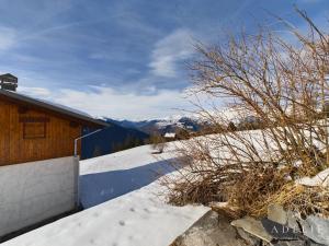 a building with snow on the ground next to a mountain at Appartement Montvalezan-La Rosière, 6 pièces, 6 personnes - FR-1-398-662 in Montvalezan