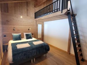 a bedroom with a bunk bed and a staircase at Chalet Les Gets, 8 pièces, 14 personnes - FR-1-598-161 in Les Gets