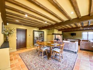 a dining room with a wooden table and chairs at Oaklands Farm - Cottage 5 in Broughton