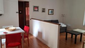 a living room with a table and red chairs at Le Mie Stelle in La Spezia