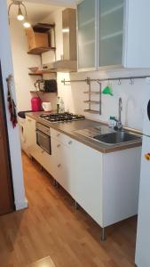 a kitchen with a sink and a stove top oven at Le Mie Stelle in La Spezia