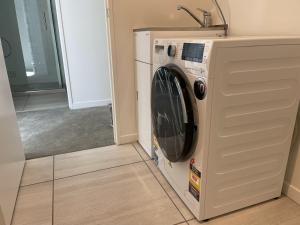 a washer and dryer sitting in a room at Harbor View Two Bedroom Apartment At Pinnacle in Wellington