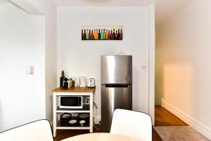 a kitchen with a stainless steel refrigerator and a microwave at Sunny Apartment in Surry Hills in Sydney
