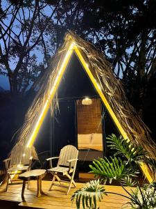 une yourte avec deux chaises et une table dans l'établissement ALMAH GLAMPING, à Cali