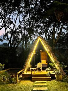 a tent with a table and chairs in front of it at ALMAH GLAMPING in Cali