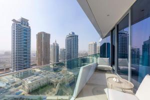 a balcony with a view of a city with tall buildings at Ultra Luxury Dubai Marina - Stella Maris Tower in Dubai