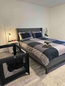 a bedroom with a large bed with blue and gray sheets at Walking distance to St Boniface, easy parking in Winnipeg