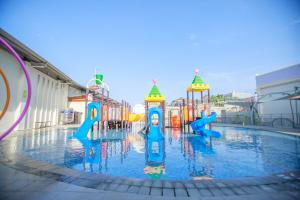 a pool with a water park with a water slide at Two K Azana Style Hotel Bengkulu in Bengkulu