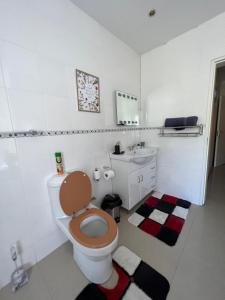a bathroom with a toilet and a sink at The Silver Gates Bed and Breakfast in Mbabane