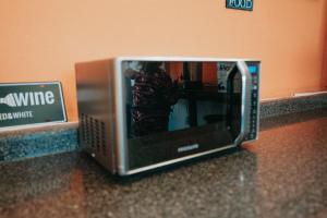 a microwave sitting on a counter with a person inside at Tequila Sunrise Hostel in Guatemala