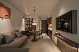 a living room with a couch and a dining room at Su Casa Phu Quoc Long Beach in Phú Quốc