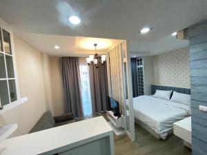 a bedroom with a bed and a television in it at Easy Easy2 @ The blu x in Ban Bang Saen (1)