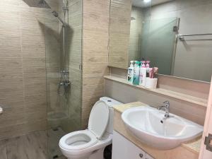 a bathroom with a toilet and a sink and a shower at Easy Easy2 @ The blu x in Ban Bang Saen (1)