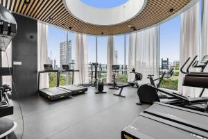 a gym with a large window with tread machines at Zi apartments - with Balcony, Bayview, Sauna and Pool in Melbourne
