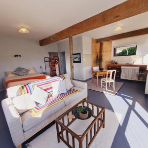 a living room with a couch and a bed at Mountain View Studio in Raglan