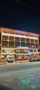 a building with benches in front of it at night at Pruthvi Paradise in Tumkūr